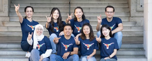 Texas Global exchange students pose in a group shot while showing of their Longhorn pride